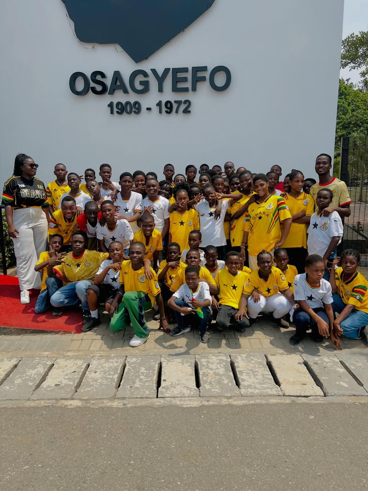 Learners gathered beneath the Osagyefo memorial on an excursion