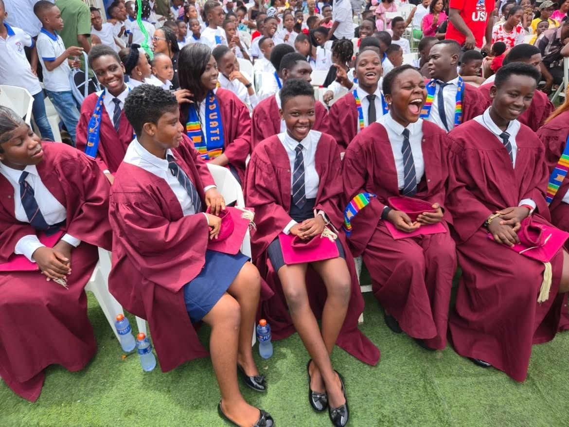 St. Jude's graduands in gowns and kente on graduation day